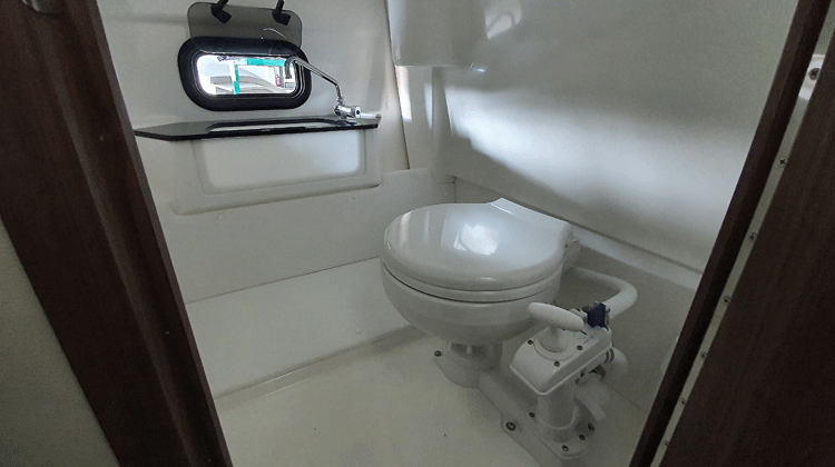 Separate toilet compartment that includes sink with solid walnut frame and lockable door